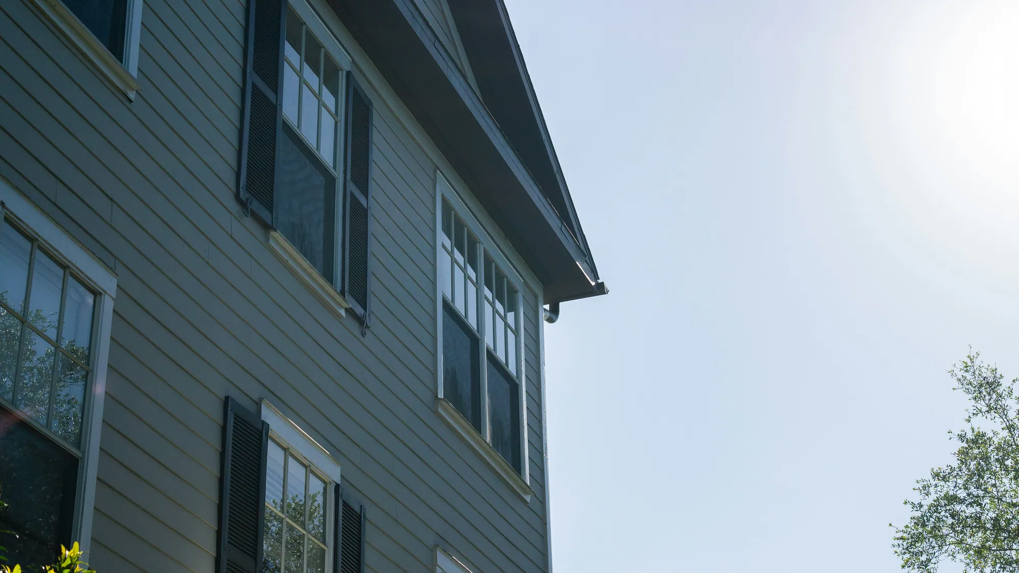 Corner of a house with lap siding against the sky
